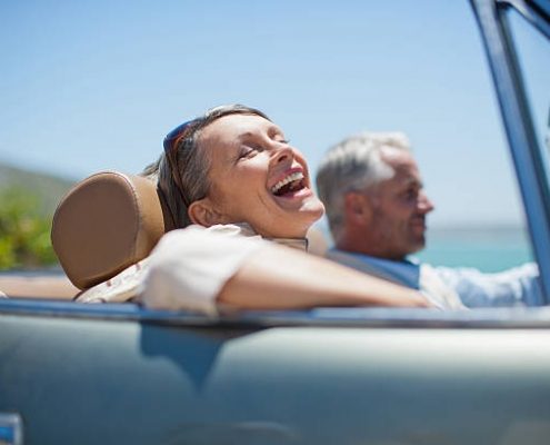 Senior citizens laughing on a dock